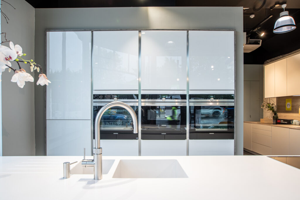 modern white kitchen island with tall units and AQC units